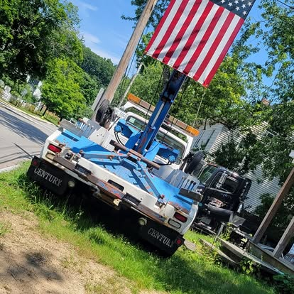 Liberty’s blue and white tow truck flying an American flag